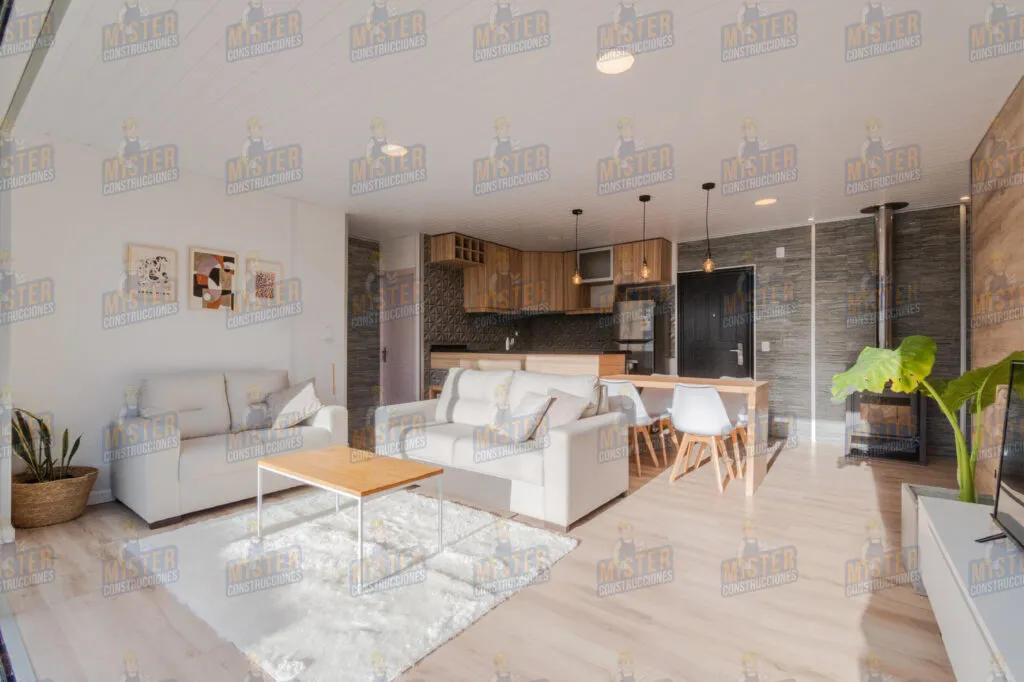 Sala de estar moderna con sofá blanco, mesa de café y comedor, junto a la cocina y estufa